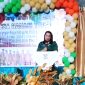 Camat Poigar, Alfina Sumenda saat memberikan sambutan di HUT Desa Nanasi Timur.